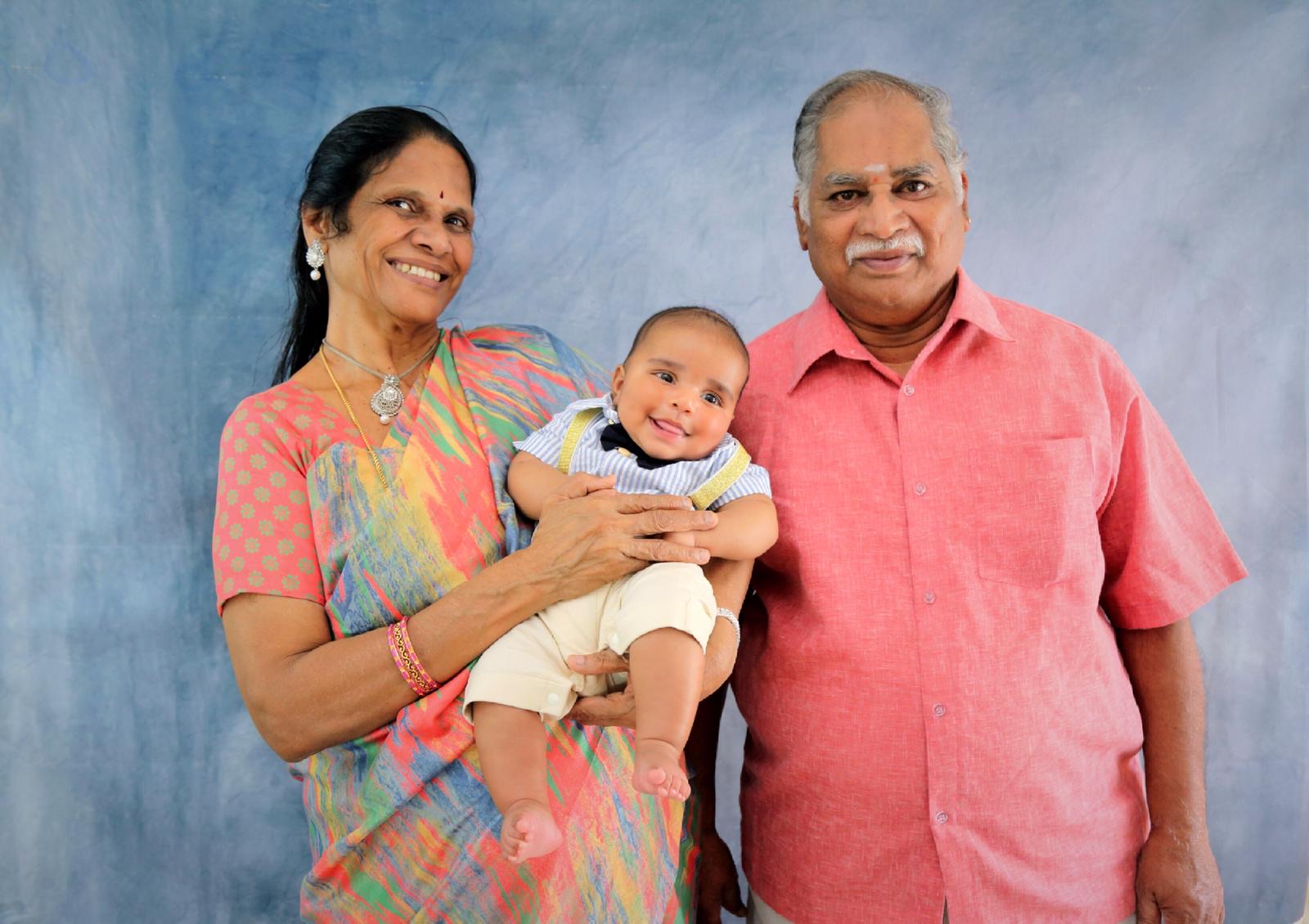 Grandparents holding their grandson